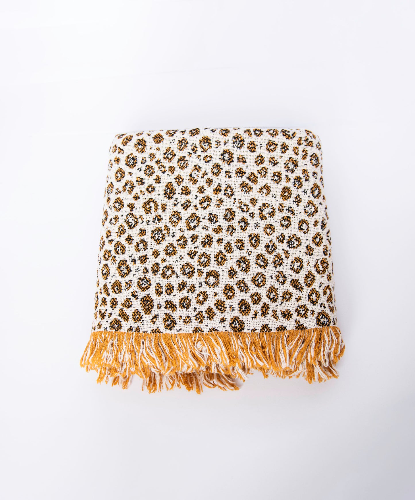 Front view of folded cream and golden leopard-print woven cotton throw on a white background